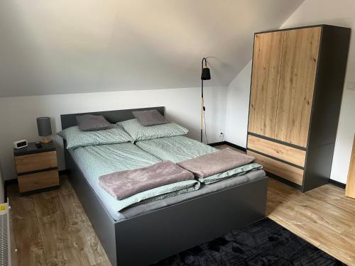 a bedroom with a bed and a dresser in it at Nest Haus in Ludwikowice Kłodzkie