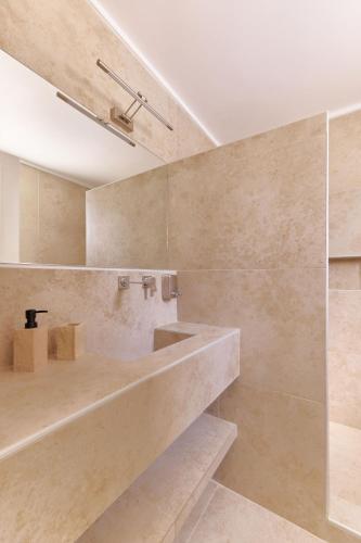 a bathroom with a tub and a sink at Villa Irini in Porto Heli