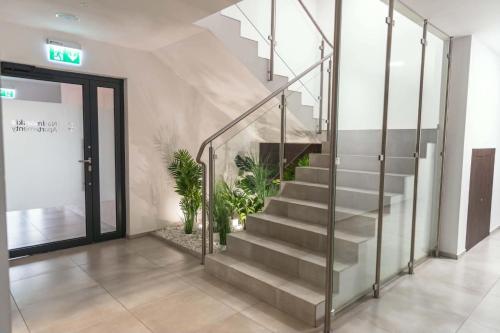 a staircase in a building with a stair case at Apartament Baltic Prestige in Gąski