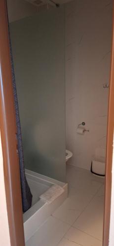 a bathroom with a glass shower with a toilet at PENZION EUROPA Diakovce in Diakovce