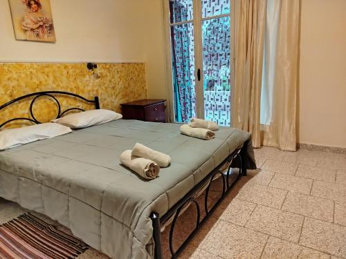 a bedroom with a bed with towels on it at Vanilla House Paleokastritsa in Paleokastritsa