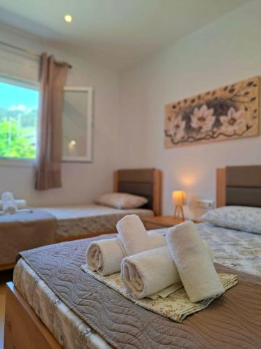 a hotel room with two beds with towels on a bed at Villa Eleni Apartment no2 in Agios Gordios