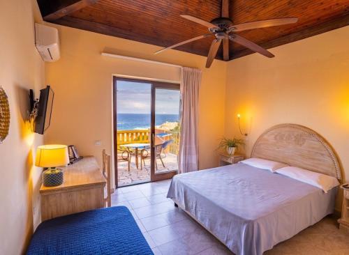 a bedroom with a bed and a view of the ocean at Hotel Costa Paradiso in Costa Paradiso