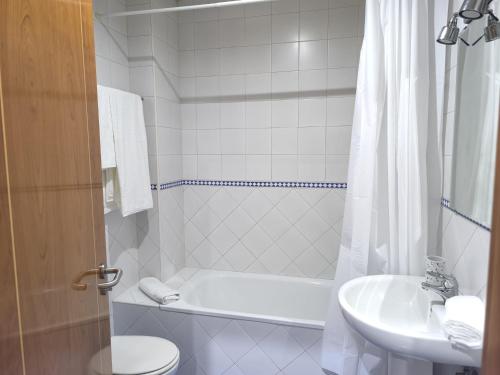 a bathroom with a tub and a sink and a toilet at Lux Sevilla Elegance in Seville