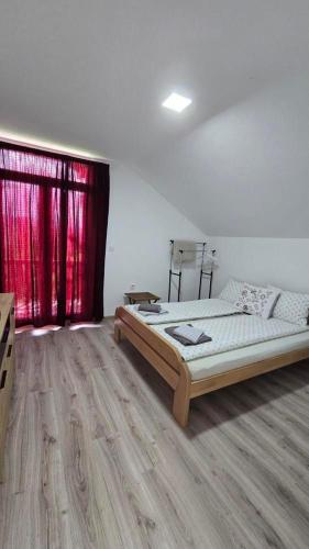 a bedroom with a bed and a red curtain at Villa La Vida in Sarajevo