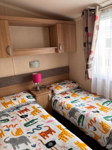 two beds in a small room in a caravan at Seton Sands in Port Seton