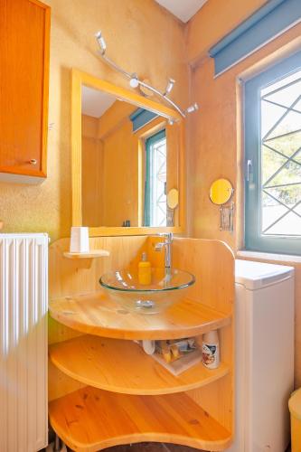a bathroom with a sink and a mirror at Fragola in Pefkali