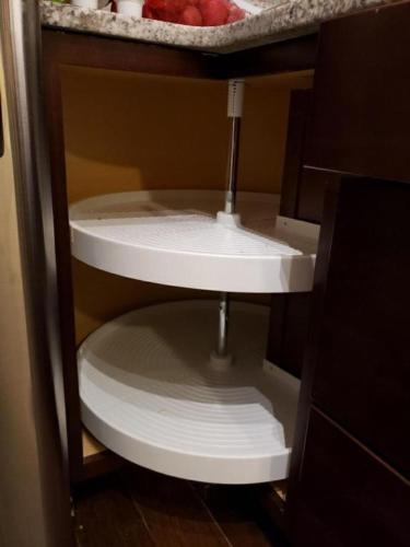 a white toilet in a cabinet in a bathroom at Parson Creek Cozy suite in Fort McMurray
