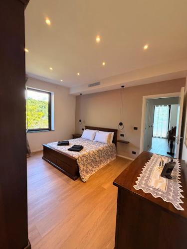 a bedroom with a large bed and a wooden floor at Oasi di Comago in Sant'Olcese