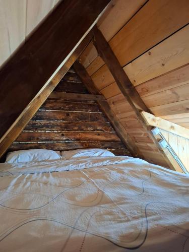 a bed in the attic of a room at Cottage MANSION in Žabljak