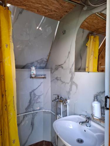 a white bathroom with a sink and a shower at Cottage MANSION in Žabljak