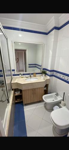a bathroom with a sink and a toilet and a mirror at Villa comfort in Bouznika