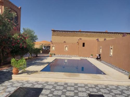 a swimming pool in the courtyard of a house at Moon Dunes camp in Adrouine