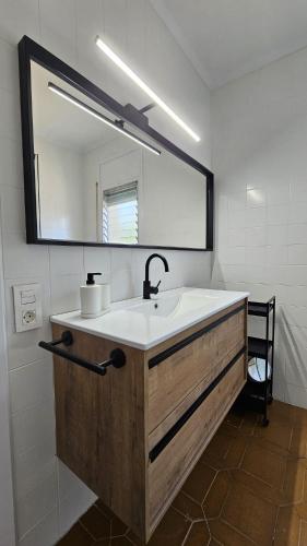 a bathroom with a sink and a large mirror at La Sènia in Miravet