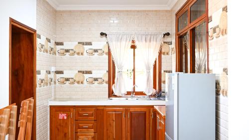 a kitchen with a sink and a refrigerator at La Vue De Mer in La Digue
