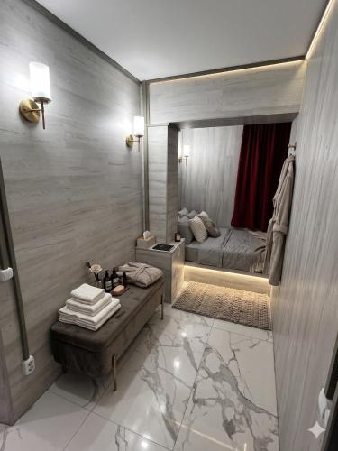 a bathroom with a mirror with a bed in it at Ismail 94-1 Apartments in Chişinău