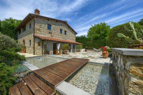 an external view of a house with a swimming pool at Mhateria Relais - Relax in Villa con Piscina in Toscana in Rignano sullʼArno