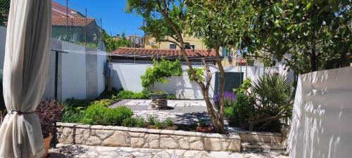 a backyard with a white fence and a garden at Active Apartments Koper in Koper