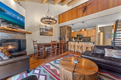 a living room with a fireplace and a dining room at Bed-N-Bliss in Kings Beach