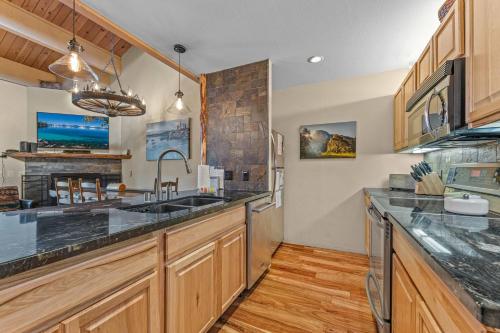 a large kitchen with wooden cabinets and a sink at Bed-N-Bliss in Kings Beach