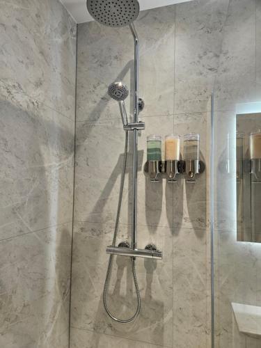 a shower with a glass door in a bathroom at Langhouse Castle Bed and Breakfast in Inverkip