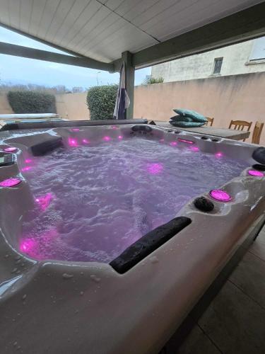 a jacuzzi tub with pink lights in it at Riba d'aude in Carcassonne