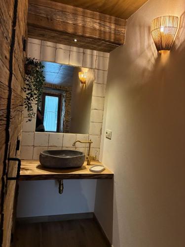a bathroom with a sink and a mirror at A casiña do Rieiro in San Pelayo
