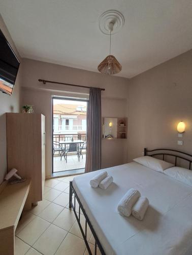 a bedroom with a large bed with two pillows on it at House Psichoula in Sarti