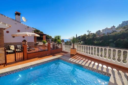 a swimming pool on the balcony of a house at Villa Alabarce Nerja by Spain Sun Rentals in Nerja