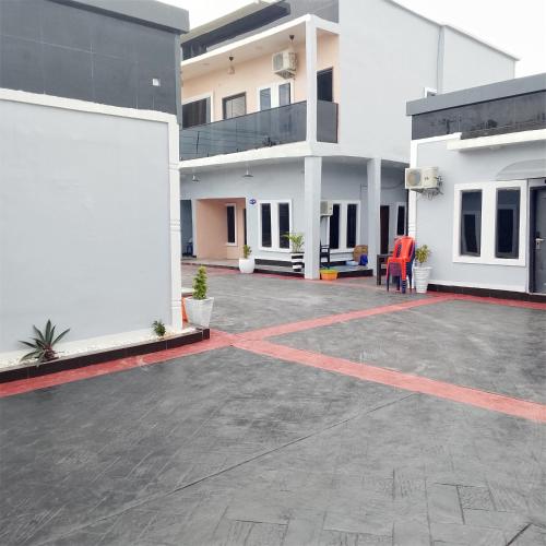 an empty parking lot in front of a building at Bluetel Hotel and Suites Limited in Sapele