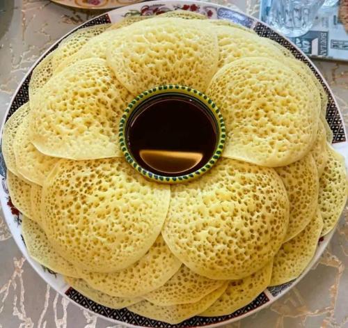 a cake on a plate on a table at Chez Malika in Oulad el Guern