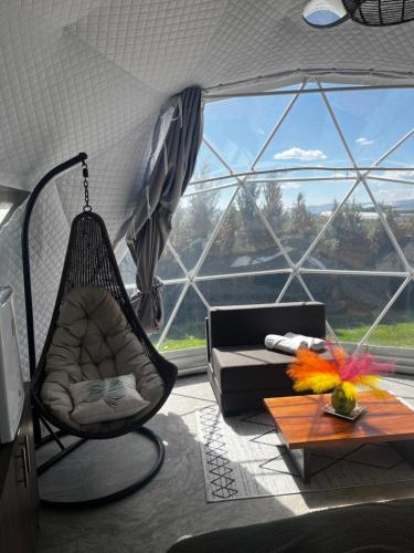 a living room with a hammock and a large window at Quinta Paco de Lucía in Hacienda Santa Rosa