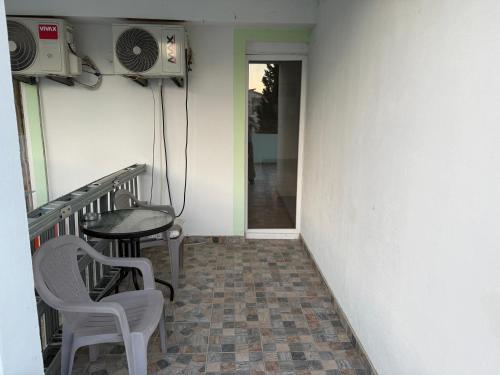 a balcony with a table and chairs and a table at Green Villa in Šušanj