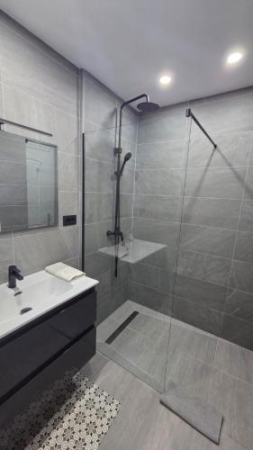 a bathroom with a shower and a sink and a shower at Callao Sun & Pool by Diamanteholidays in Callao Salvaje