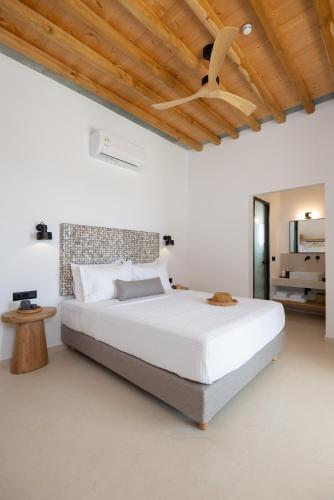 a bedroom with a bed and a ceiling fan at Refoulia Eco Suites in Vathi
