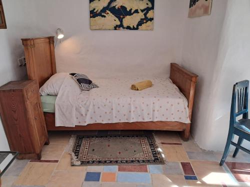 a small bedroom with a bed and a rug at U Kameníků in Lhenice