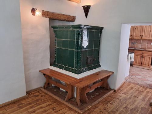 a room with a green counter and a wooden table at U Kameníků in Lhenice