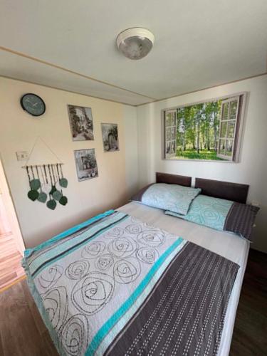 a bedroom with a large bed in a room at Mobilheim Výr in Výrovice