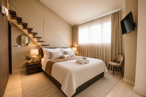 a bedroom with a bed and a staircase at Apartments Villa Marid in Opatija