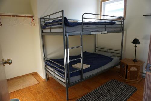 two bunk beds in a room with a window at HI Rossburn 9 Finger Ranch in Rossburn