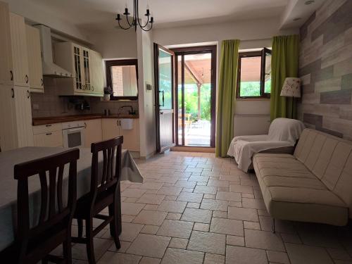 a kitchen and a living room with a couch and a table at Morrovalle LOVE in Morrovalle