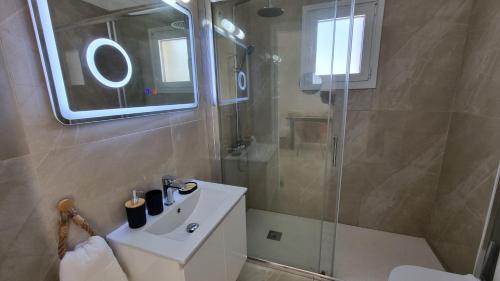 a bathroom with a white sink and a shower at Nerina 3 Luxury Villa in Paphos