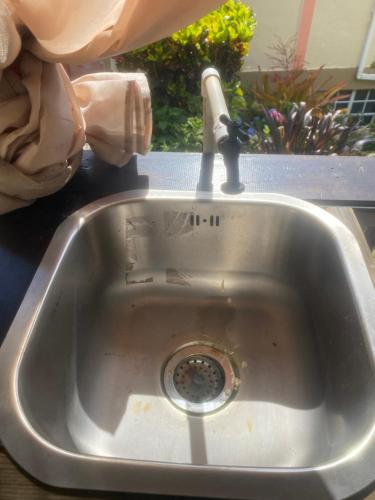 a kitchen sink with a faucet in it at anthurium cabin in Trafalgar