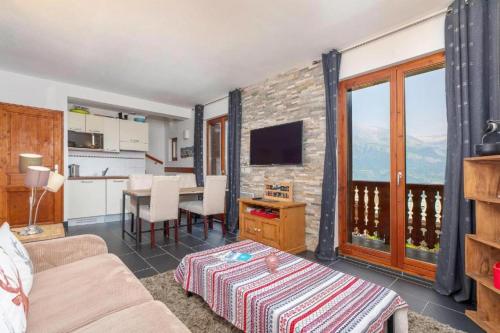 a living room with a couch and a table at Résidence Les Aiguilles de Warens - Combloux in Combloux