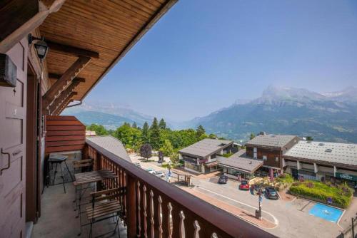 a balcony with a view of a town and mountains at Résidence Les Aiguilles de Warens - Combloux in Combloux