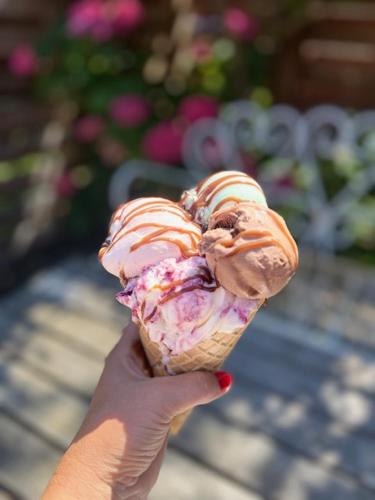 a person holding a ice cream cone with frosting and sprinkles at Langø Fjord Glamping NR 2 in Nakskov