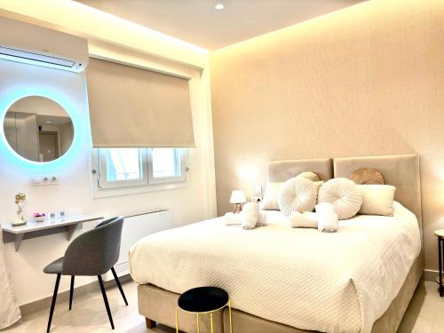 a bedroom with a bed with a desk and a chair at The Corfu Urban Stays in Ágios Rókkos