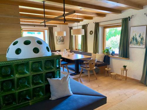 a living room with a couch and a table at Ferienhaus Eichenseer Gallzein - Alleinlage mit Garten, Wald & Bergblick in Gallzein