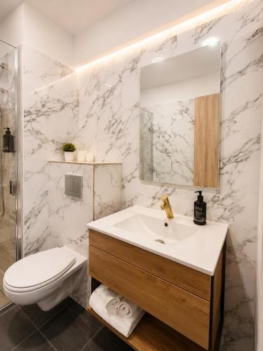 a white bathroom with a sink and a toilet at Asi Marine Rentals in Saturn