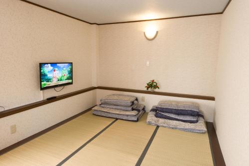 Cama o camas de una habitación en Guest House Izumi
